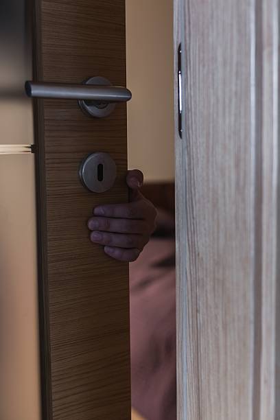 istock Hand reaching from behind door 510490586