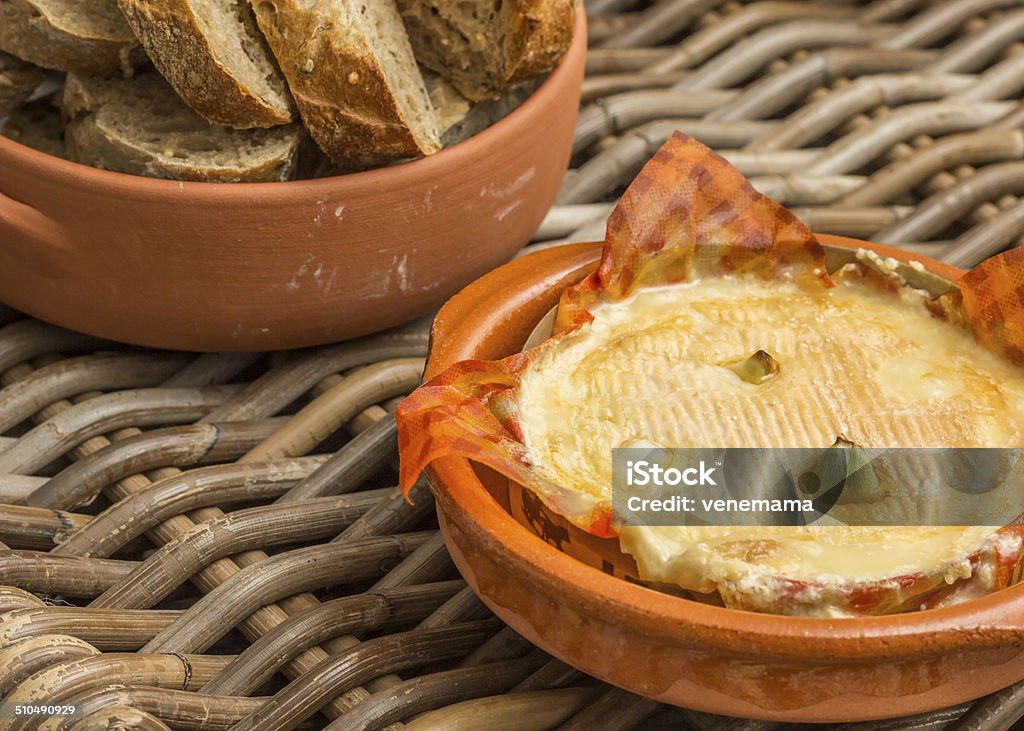 French camembert baked with garlic French camembert baked with garlic, served with bread Appetizer Stock Photo