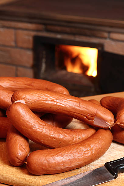 istock Sausages at wood burning oven background 510491006