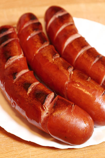 istock Grilled sausages on disposable paper plate 510491884