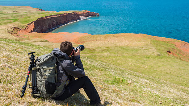 Photographer at the work on the beach. Photographer at the work on the Beach - Magdalen Islands (îles de la Madeleine), Quebec, Canada. gulf of st lawrence photos stock pictures, royalty-free photos & images