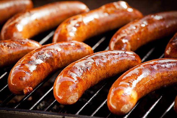BBQ Sausages Bunch of tasty sausages on the grill sausage stock pictures, royalty-free photos & images