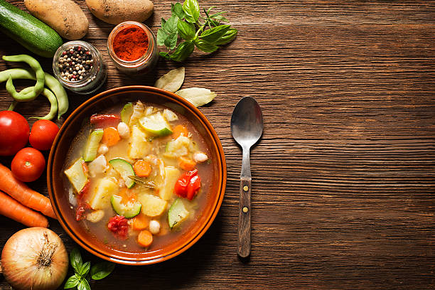 Vegetable stew Fresh vegetable stew on wooden background overhead shoot soup stock pictures, royalty-free photos & images