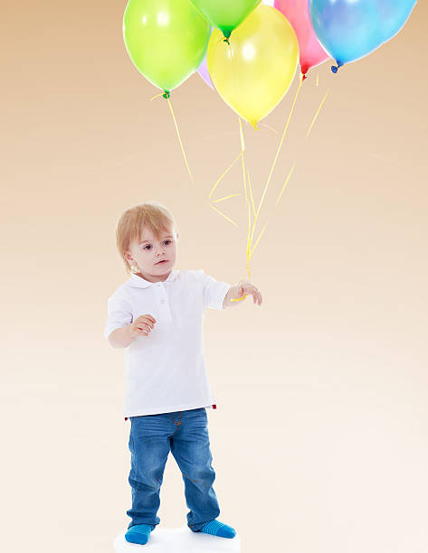 istock Little boy launches balloons. 510495767