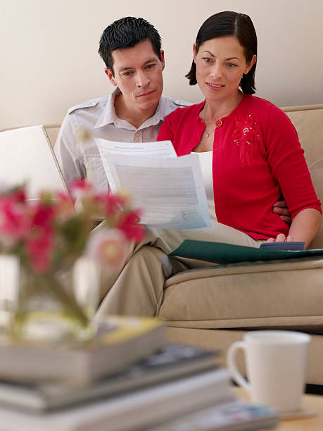 istock Couple With Laptop And Bills On Sofa 510511401