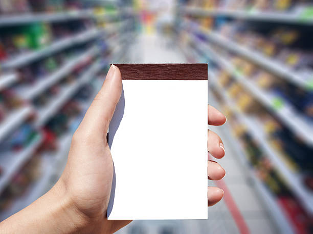 blank notebook and supermarket background stock photo