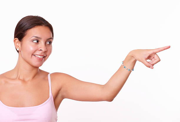 istock Cute brunette pointing and looking to her left 510512541