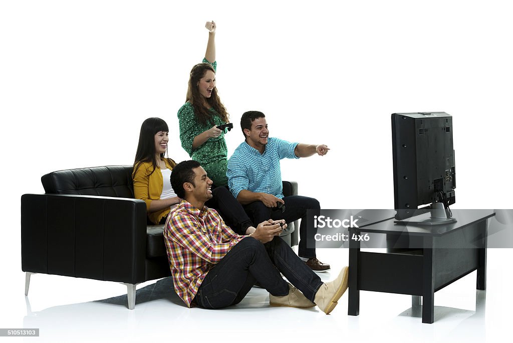 Group of friends playing video game & cheering Group of friends playing video game & cheeringhttp://www.twodozendesign.info/i/1.png Friendship Stock Photo