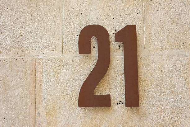 istock House number twenty one attached to a stone wall. 510515659