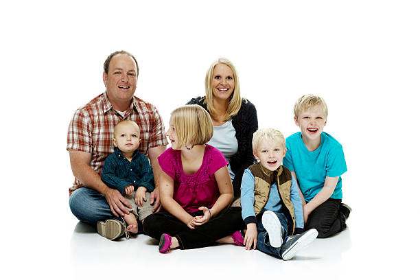 istock Happy family sitting on floor & looking at camera 510515871