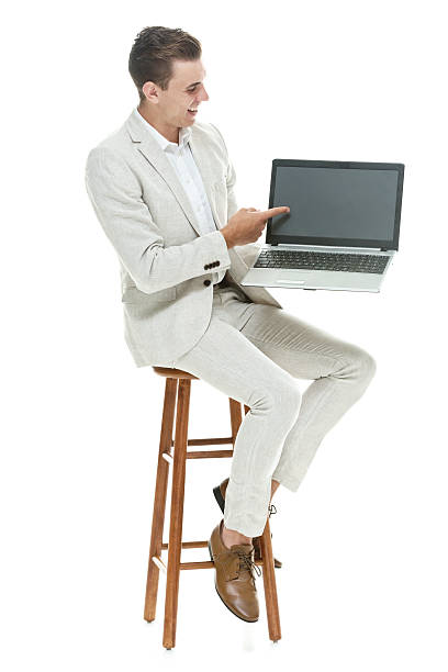 istock Smiling businessman pointing at laptop 510516273