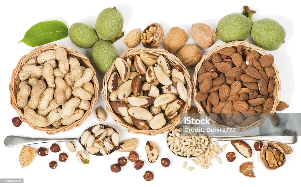 Top view of variety of nuts Assorted nuts in a wicker bowl isolated on a white. View from above. Peanut - Food Stock Photo