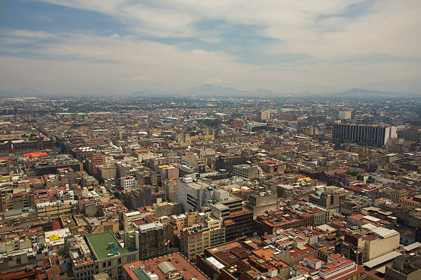 Mexico city DF aerial view with mountains and clouds