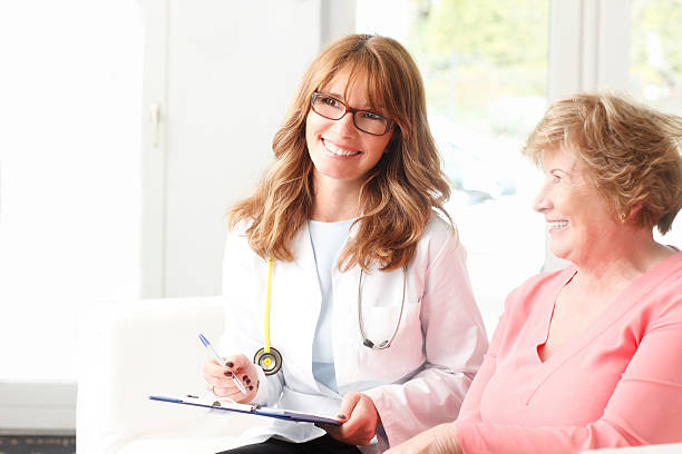 istock Female doctor with senior patient 510519133