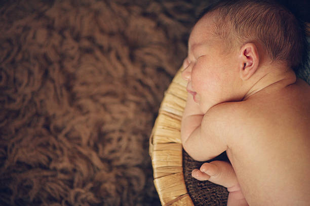 istock Newborn Baby Boy Sleeping Peacefully in Basket 510533055