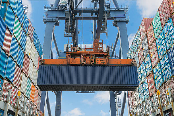 istock Shore crane lifts container during cargo operation in port 510534093