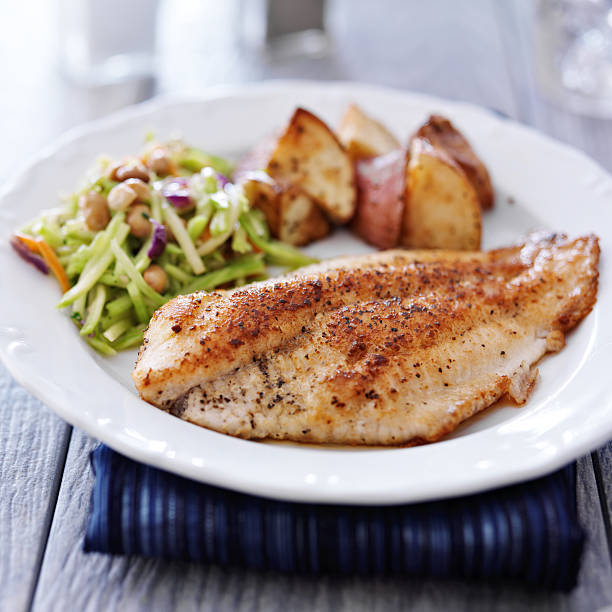 istock pan fried tilapia with asian slaw and roasted potatoes 510538477