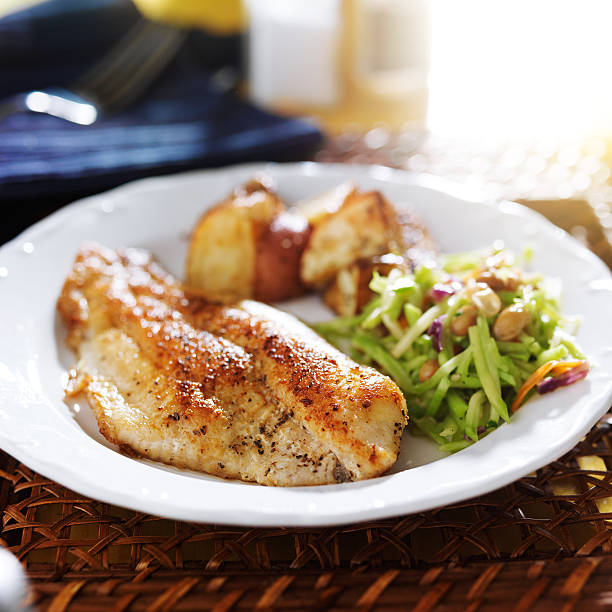 istock pan fried tilapia with asian slaw and roasted potatoes 510538679