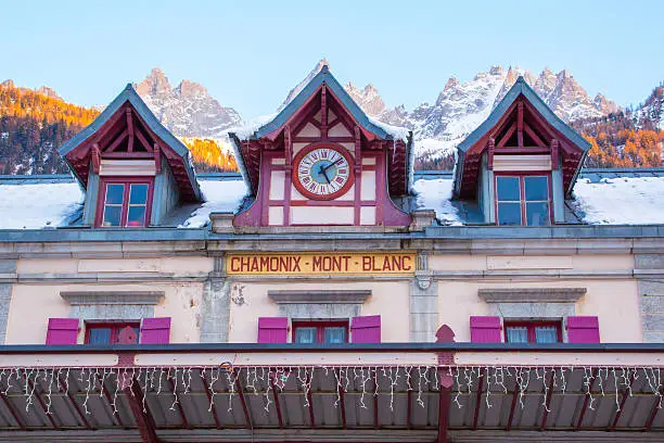 Facade of Chamonix train station near Mont Blanc, France, Frenck Alps and mountain peaks lightened with sun on the background