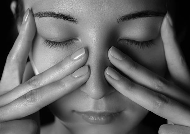 Woman holds her nose