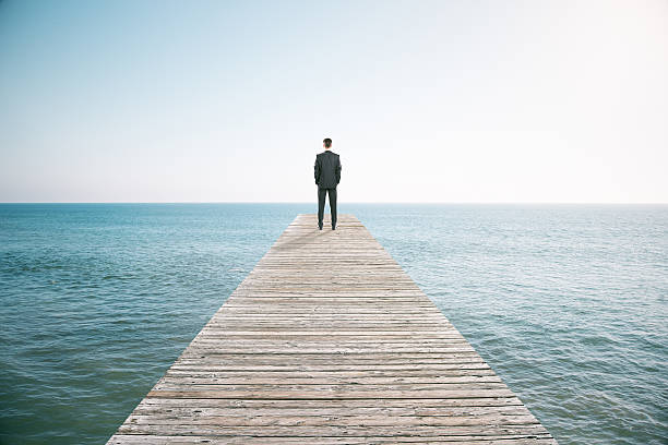 istock Man standing on the pier and looking into the distance 510562016