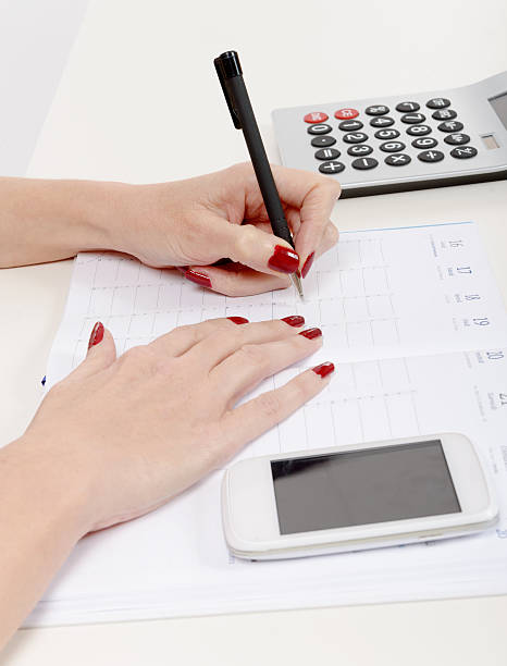 istock Closeup of woman's hand writing on organizer 510562478