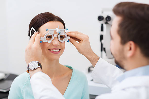 istock optician with trial frame and patient at clinic 510562568