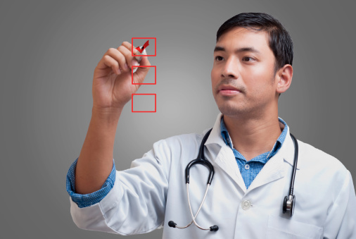 Young physician ticking up the checklist boxes