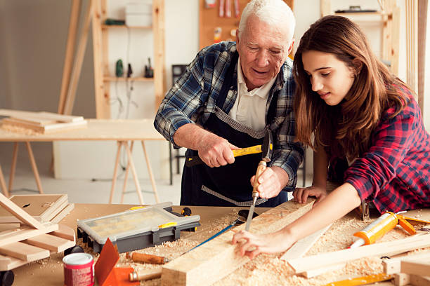 istock Girl with grandpa at workshop 510563200