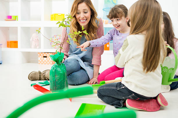 istock Children learning about planting a tree in a kindergarden 510563371