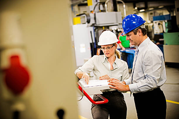istock Manager and Female Engineer in the Factory Disscusing Project 510563377