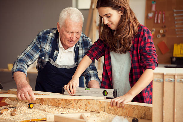 istock Girl helping grandpa at workshop 510563814