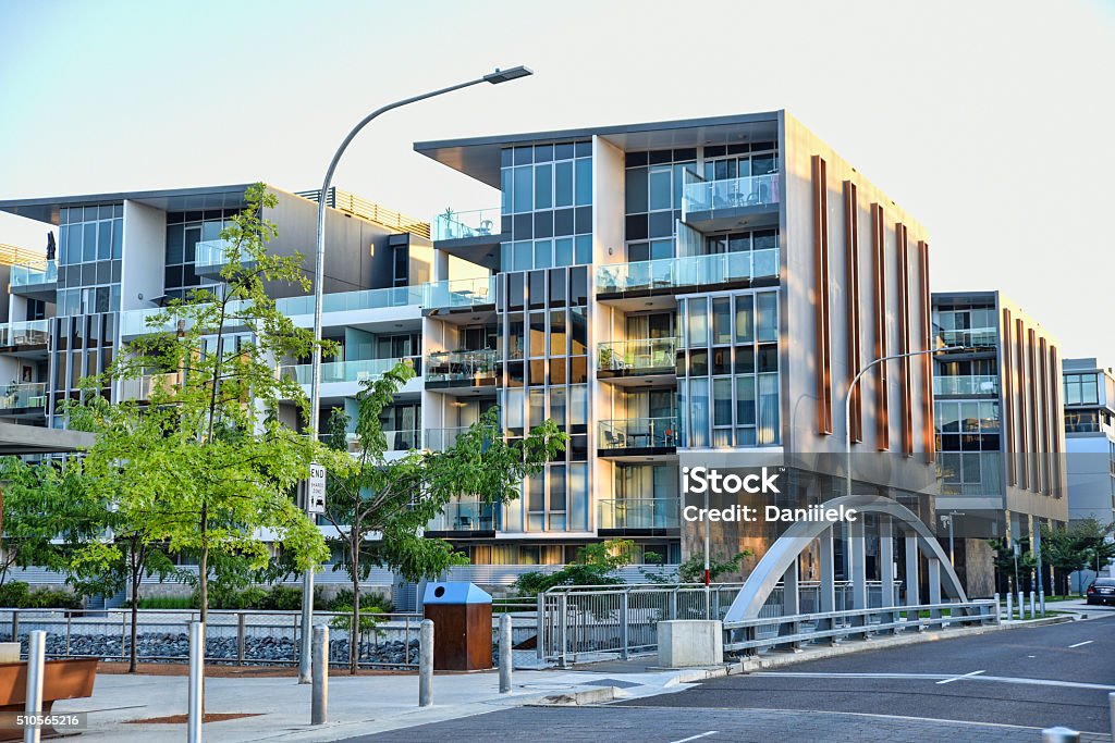 Trendy Kingston Foreshore suburb along the canal to the lake Canberra, Australia, 10 February 2016. Canberra street early morning, in the trendy Kingston Foreshore suburb. Land was reclaimed from the lake  Burley Griffin to create a small island. The canal joins the lake to the new harbour. Apartment Stock Photo