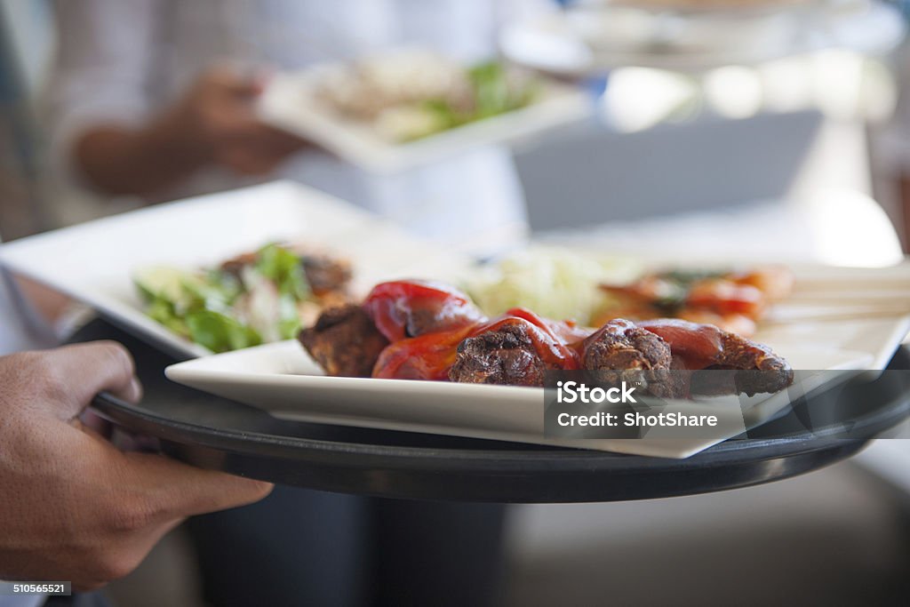 Waitress serving food Arrangement Stock Photo