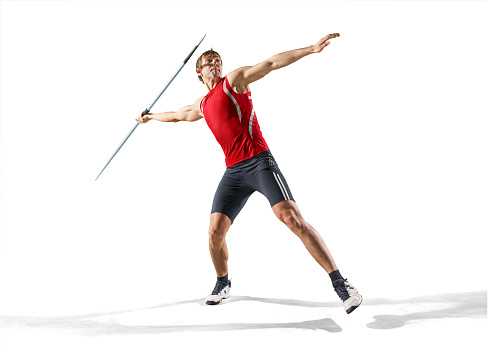A young male athlete with a javelin isolated on a white background