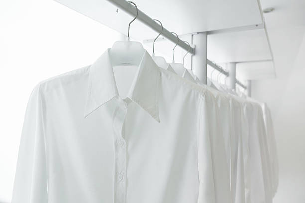 istock white shirts hanging on built-in cloths racks 510565879