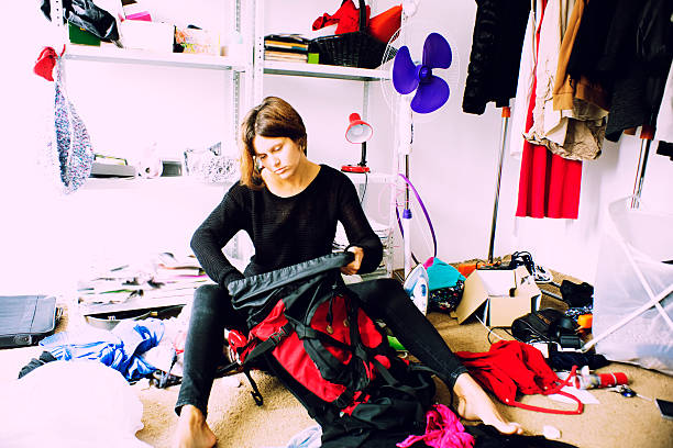 istock woman is packing backpack in a messy room 510565901
