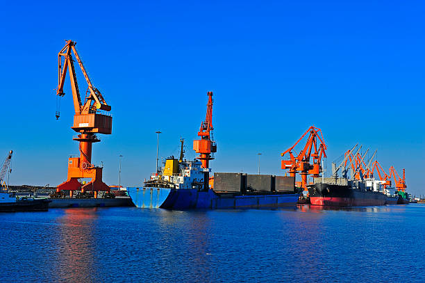 istock Port crane bridge and bulk carrier 510566450