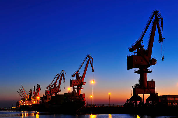 istock Port crane bridge and bulk carrier 510566574