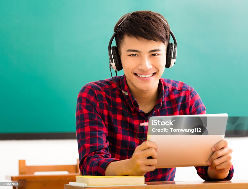 happy student reading tablet in classroom Headphones Stock Photo