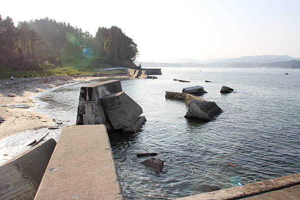 Minamisanriku, Japan - Jul 10, 2012:  This picture was taken 1 year and 4 moths after 2011 Tohoku earthquake and tsunami disaster, giving an idea of the destruction that the tsunami left on the territory. Minamisanriku was cleaned up, and slowly recovering from disaster. Photo is taken on the road 398 at Hadenya Tokura. 