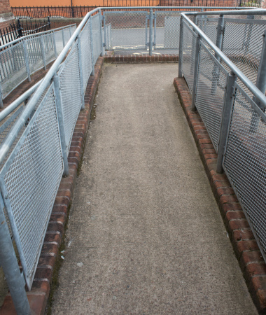 The narrow and dilapidated public pedestrian walkway by the overpass