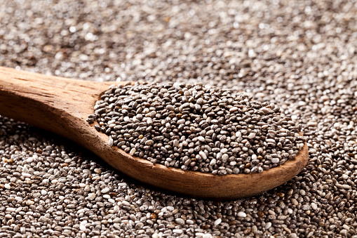 Wooden spoon with chia seeds. DSRL studio photo taken with Canon EOS 5D Mk II and Canon EF 100mm f/2.8L Macro IS USM