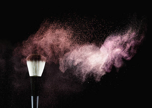 Brush with powder Make-up brush with multicolored powder explosion on black background. Studio shot using high speed technique.   make up brush stock pictures, royalty-free photos & images