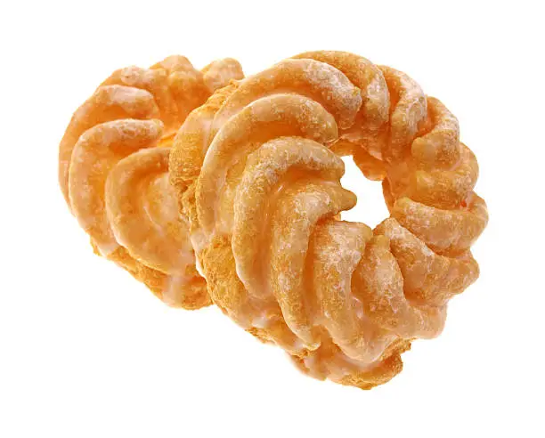 Two fluted crullers with one leaning atop the other against a white background.
