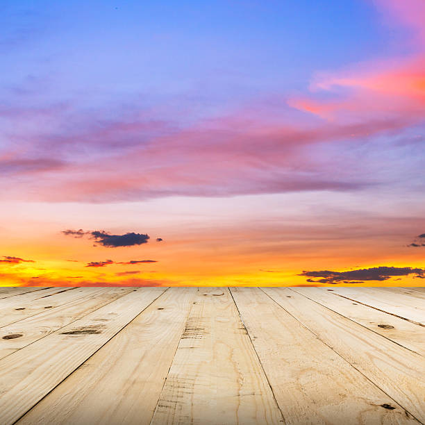 istock wood floor and sky sunset with space 510570028
