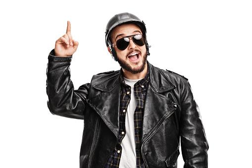 Studio shot of a young male biker having an idea and looking at the camera isolated on white background