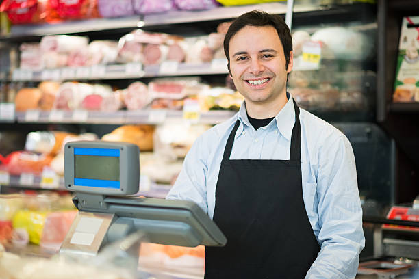 sonriendo shopkeeper - butchers shop meat market pork fotografías e imágenes de stock