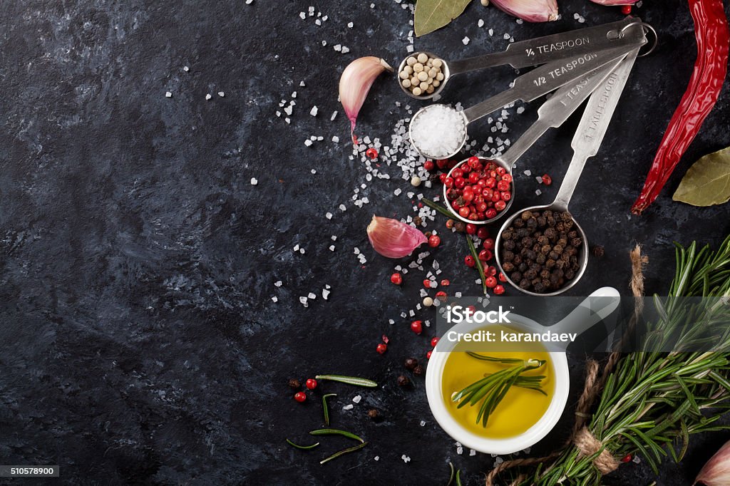 Herbs and spices over black stone Herbs and spices over black stone background. Top view with copy space Above Stock Photo