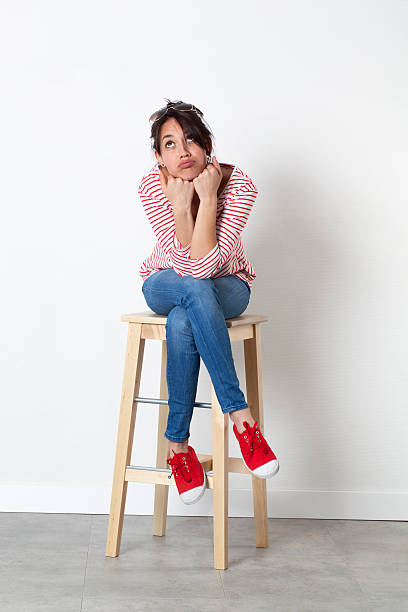 istock pouting 20s woman with cheeks puffed out looking bored 510580164